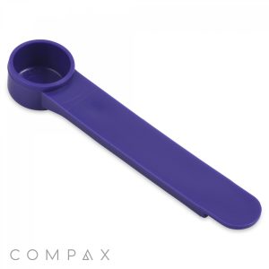 The 1.25cc Scoop, a blue plastic lever tap turner designed to assist in turning difficult taps, features a shallow cup shape at one end to fit over tap handles and a flat, elongated arm for easy gripping. The brand name "COMPAX" is visible in the bottom left corner.