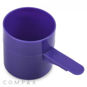 A 73cc purple plastic measuring scoop featuring a flat thumb grip handle on a white background, branded with the name "COMPAX" in the corner.