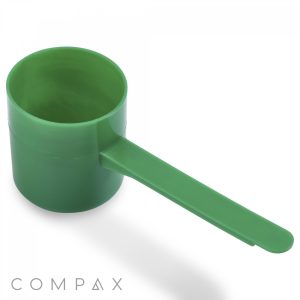 A 73cc scoop, constructed from green plastic and featuring a long handle, is displayed against a white background. The scoop has a cylindrical shape with a flat bottom. The word "COMPAX" is visible in the lower left corner of the image.