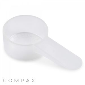 A 9cc Scoop made of translucent white plastic features a round container and a flat, extended handle. The background is plain white, and the word "COMPAX" is partially visible at the bottom of the image.