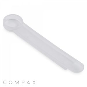 A .625cc Scoop with a translucent white plastic body features a circular loop at one end and a flat, elongated handle. The text "COMPAX" appears in grey letters at the bottom left corner of the image.