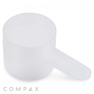 A white plastic 26.5cc Scoop with a handle on the right side is displayed against a plain white background. The brand name "COMPAX" is written in light grey text at the bottom left corner.