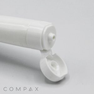 Close-up image of the open nozzle of a white plastic tube. The cap is hinged and partially visible, showing the opening through which contents would be dispensed. The words "16mm Flip Top" appear in the bottom-left corner.