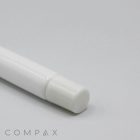 Close-up of the bottom end of a white 13mm Lip Applicator with a round cap placed on a light gray surface. The word "COMPAX" is subtly visible in lowercase letters near the bottom left corner of the image.