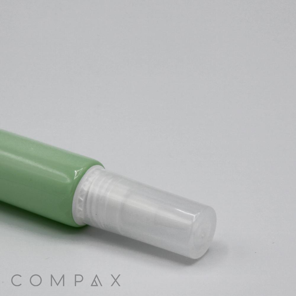 Close-up image of a green spray bottle with a white plastic nozzle cap. Part of the bottle and cap are visible, set against a plain background. The word "19mm Brush Applicator" is faintly visible at the bottom left of the image.