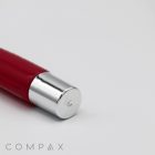 A close-up of a red 19mm Roller with a silver metal cap on its end placed against a white background. The brand name "COMPAX" is displayed in small print at the bottom left corner of the image.