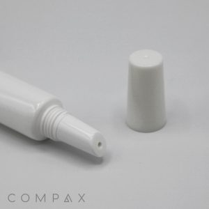 A 19mm Lip Applicator, characterized by its white, cylindrical plastic design with the cap removed, is displayed against a plain background. It features a narrow, pointed nozzle for precise dispensing of its contents.
