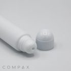 A 19mm Lip Applicator, featuring a white cylindrical tube with a detached cap placed next to its open end. The dispensing end has a small hole for applying the product. The word "COMPAX" is printed in gray at the bottom left corner of the image.