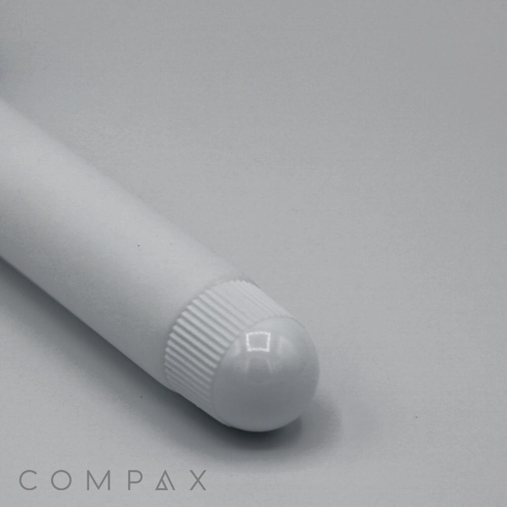 A close-up view of a 19mm Lip Applicator, showcasing its white cylindrical body with a rounded, ribbed cap, resting on a light grey surface. The word "COMPAX" is partially visible in the bottom left corner.