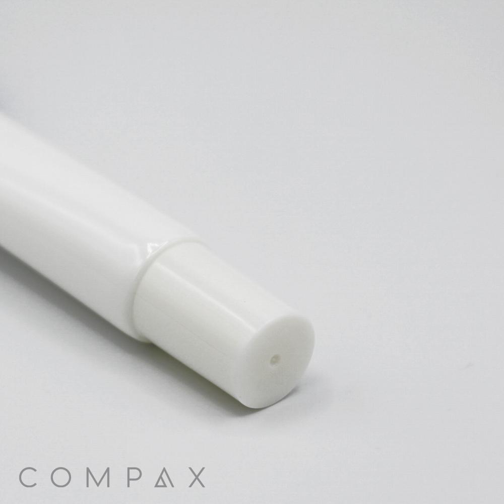 Close-up view of a white cylindrical object with a removable cap lying on a plain, white surface. The word "19mm Needle Nose" is faintly visible in small letters in the lower-left corner of the image.