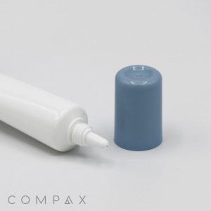 A white tube with a pointed nozzle, placed next to a detached gray cap. The tube lies horizontally on a white surface, and the cap stands upright. The product name "19mm Needle Nose" is printed at the bottom left corner of the image.