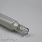 A close-up photo of a silver and transparent cosmetic bottle with a clear cap, laying horizontally. The brand name "COMPAX" is visible in the bottom left corner. The background is plain white. This product is labeled as the "25mm Dropper Tip.