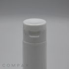 A close-up image of a white plastic bottle with a 30mm flip-top cap. The lid features a slight lip for easy opening. The background is plain and light grey, with the subtle text "COMPA X" visible at the bottom left corner.
