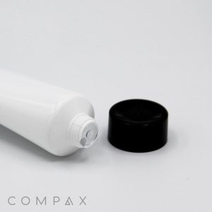 A 30mm Screw Top white squeeze tube with the cap off, revealing the sealed opening of the tube. The black cap is positioned next to the tube, showcasing an intact inner seal. The brand name "COMPAX" is visible in the bottom left corner of the image.