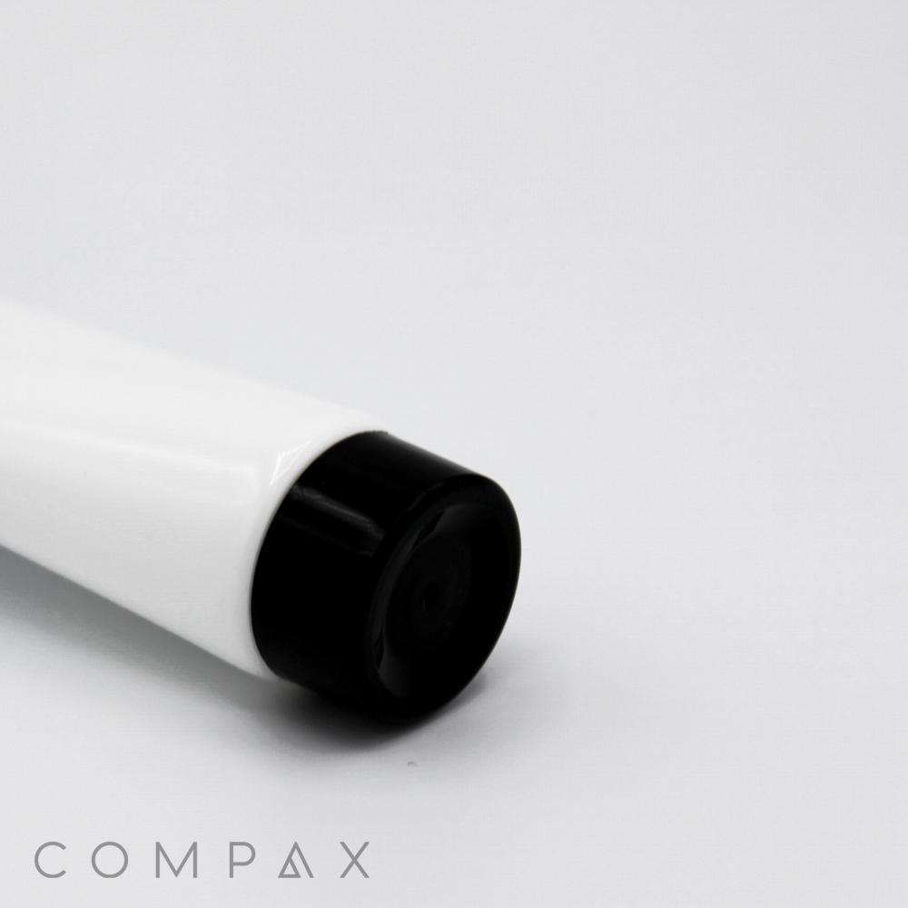 Laid down on a plain white surface is a white tube with a black cap, labeled with "30mm Screw Top" in gray text at the bottom left corner. The overall design is clean and minimalistic.