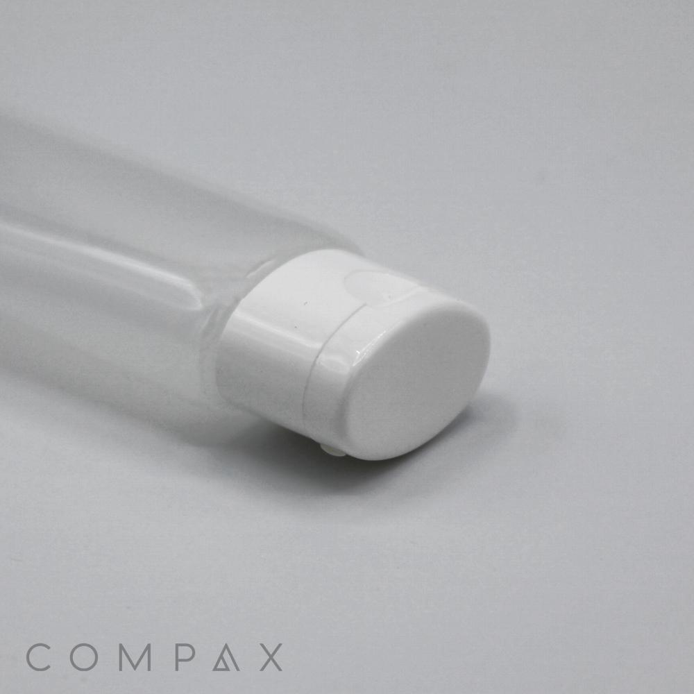 A close-up image of a transparent plastic bottle with a white cap lying on its side. The bottle appears to be empty. The words "30mm Oval Flip Top" are printed in the bottom left corner. The background is a plain, light gray surface.