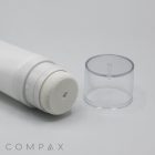 Close-up of a 35mm Sponge Applicator, featuring a white cylindrical tube with a sponge applicator tip, positioned horizontally on a plain white surface. Beside it is a transparent plastic cap. The word "COMPAX" is partially visible in light grey text at the bottom left of the image.
