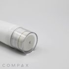 A close-up image of a white cylindrical 35mm Sponge Applicator with a transparent cap, lying on its side. The bottom part of the applicator is in focus, while the upper part is slightly blurred. The word "COMPAX" is visible in the bottom left corner of the image.