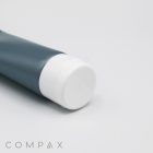 A close-up of a cylindrical, teal-colored tube with a white cap, lying horizontally on a white surface. The words "35mm Flip Top" are printed in light gray in the bottom left corner of the image.