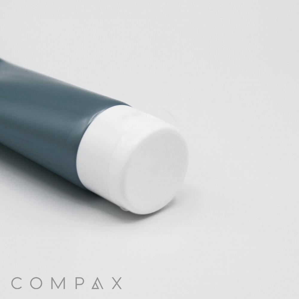 A close-up of a cylindrical, teal-colored tube with a white cap, lying horizontally on a white surface. The words "35mm Flip Top" are printed in light gray in the bottom left corner of the image.