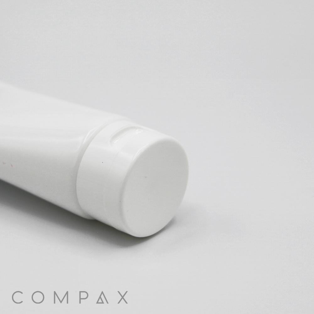A close-up image shows a white cylindrical plastic tube with a flip-top cap. On the bottom left corner, the word "40mm Flip Top" is written in light gray, minimalist font against a plain white background.