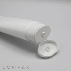 A close-up image of a white, open plastic tube of cream or gel. The tube rests on a light surface with the cap hinged open, revealing a small nozzle. The product name "45mm Oval Flip Top" is printed in a minimalistic font at the lower left corner of the image.