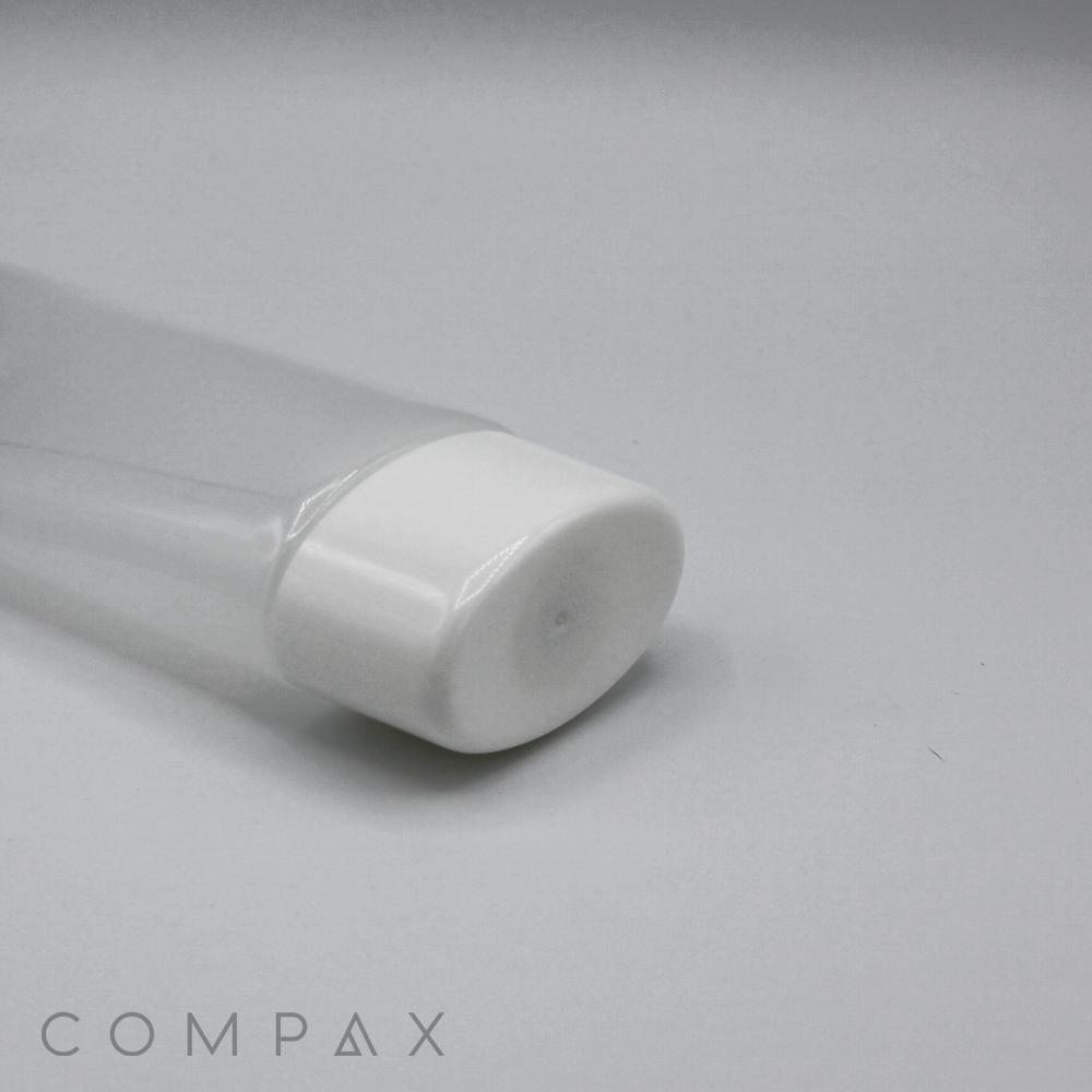 Close-up of a clear plastic tube with a white cap, positioned on a minimalist white surface. The cap is prominent in the foreground, while the product name "50mm Oval Screw Top" appears faintly in the background at the bottom left corner.