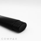 A black, 50mm oval flip top tube with a cap is placed on a white surface. The brand name "COMPAX" is visible in light gray text at the bottom left corner of the image.