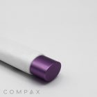 A close-up image of a 30mm Oval Screw Top with a white cylindrical container and a purple cylindrical cap, placed horizontally against a plain white background. The word "COMPAX" is visible at the bottom left corner of the image.
