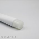 A close-up image of a white, cylindrical tube with a clear cap, likely containing a cosmetic product. The words "30mm Needle Nose" and "COMPAX" are visible at the bottom left corner of the image on a plain, light gray background.