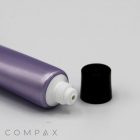 A close-up image of a purple 16mm Screw Top tube with a white nozzle, lying horizontally. The black cap is removed and placed next to the nozzle. The word "COMPAX" appears in the bottom left corner. The background is plain white.