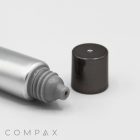 A close-up image of a gray and silver metallic 16mm Screw Top with a rounded dispensing tip and a small black cap placed beside it on a flat surface. The word "COMPAX" is printed at the bottom of the image.