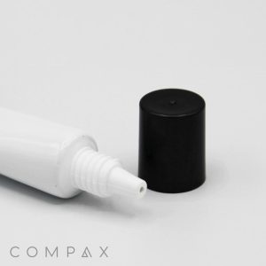 A close-up image of a white plastic squeeze tube with its black cap removed and placed beside it. The tube features a small nozzle for dispensing its contents. The product name "19mm Needle Nose" is visible in the bottom-left corner of the image.