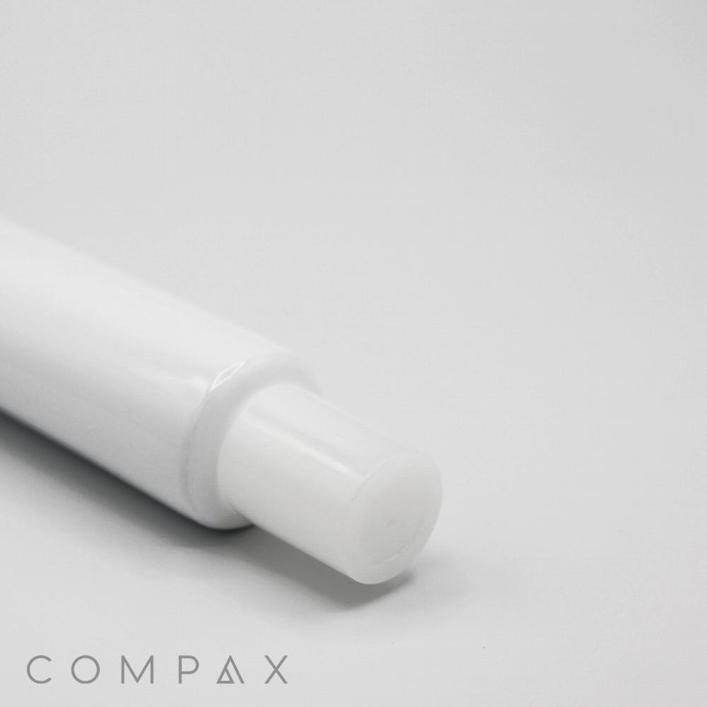 A close-up image of the 25mm Needle Nose, featuring a white cylindrical body with a smaller white cylindrical tip extending from it. The background is plain and light-colored, and the word "COMPAX" is visible in the bottom left corner of the image.