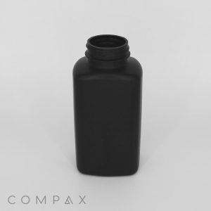 A black, rectangular plastic bottle with a screw-top lid, placed upright on a plain white background. The word "COMPAX" is visible in the bottom left corner of the image.