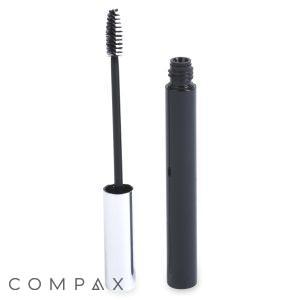 A Round Mascara Bottle with a metallic silver cap is open, revealing the brush applicator. The brush is coated with black mascara, and both the bottle and the brush are standing upright against a white background.