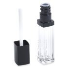 A tube of Square Lip Gloss with black accents is displayed against a white background. The cap is removed, revealing a white doe-foot applicator attached to it. The transparent container showcases the clear lip gloss inside.