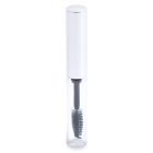 The Round Mascara Bottle is a clear cylindrical tube with a metallic silver cap, housing a black mascara wand featuring visible bristles. The wand is partially immersed in a transparent solution and the item stands upright against a white background.