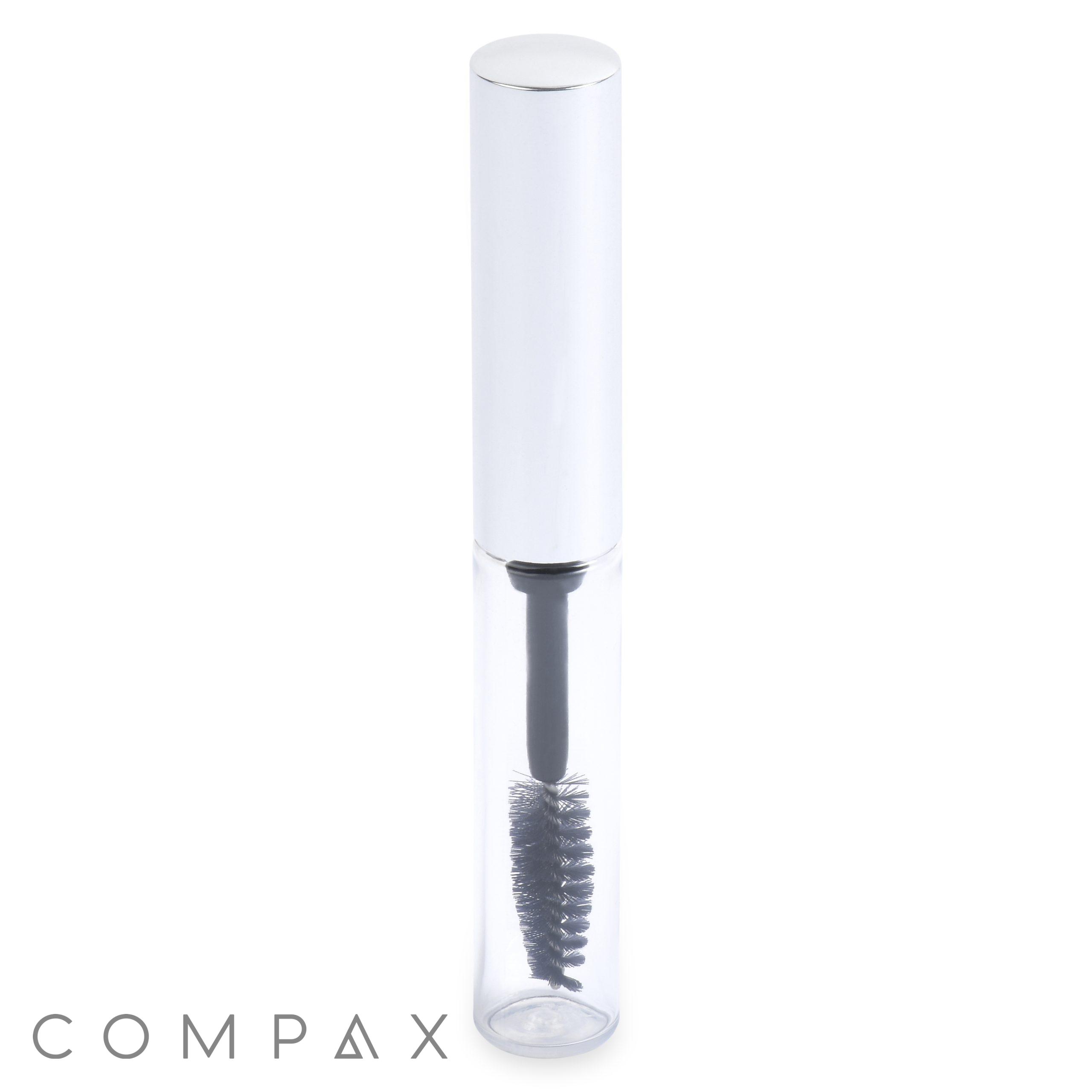 The Round Mascara Bottle is a clear cylindrical tube with a metallic silver cap, housing a black mascara wand featuring visible bristles. The wand is partially immersed in a transparent solution and the item stands upright against a white background.