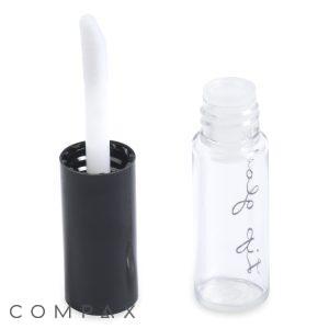 A clear, empty Round Lip Gloss Bottle with a black cap. Inside the cap is an attached white applicator wand, visible in an upright position. The bottle features some handwritten text.