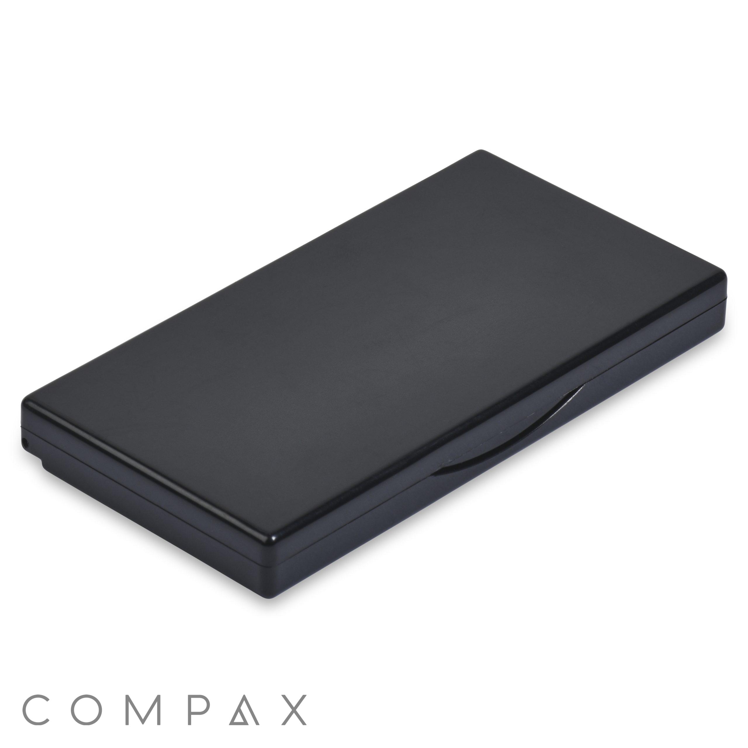 The 5 Well Rectangular Compact is a closed, black carrying case with smooth edges and a slight indentation along one side, likely for opening. The case appears compact and sleek, suitable for holding small items like utensils, electronic accessories, or writing instruments.