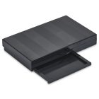 A sleek, black rectangular 9 Well Rectangular Compact with a glossy finish, featuring a slide-out compartment partially extended from the front. The compact and its compartment are adorned with subtle horizontal lines that add texture to the surface.