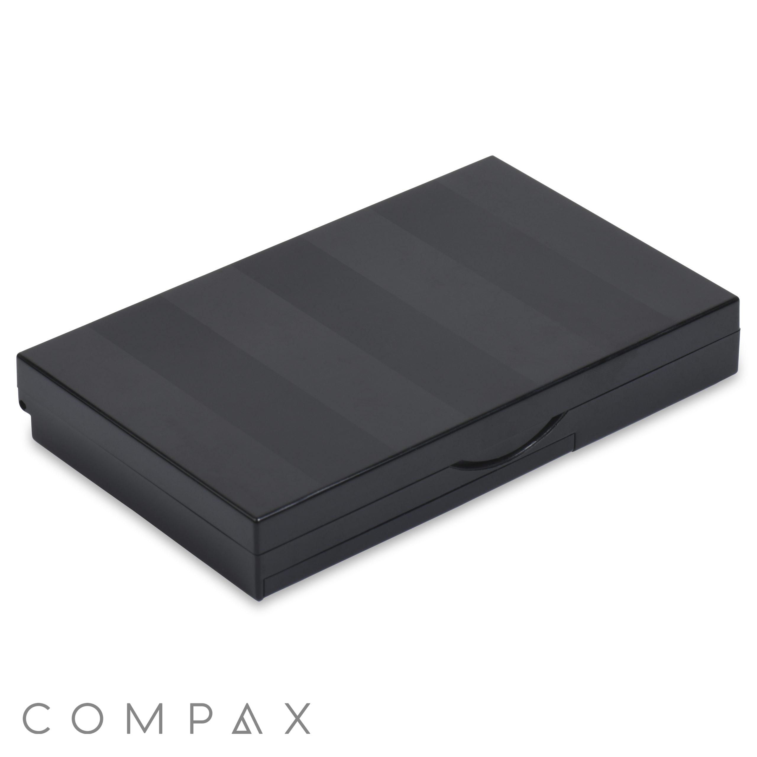 A sleek, rectangular 9 Well Rectangular Compact with subtle horizontal stripes and a small curved indentation on the front for easy opening. The compact appears to be made of a glossy material and is lying on a white background.
