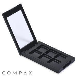 Introducing the 6 Well Rectangular Compact: A sleek, black makeup palette featuring an open lid with a built-in mirror on the inside. The base contains six empty compartments arranged in a neat 2x3 grid, ideal for holding various makeup products. This compact is perfect for personalized customization and ready to be filled with your favorite shades.