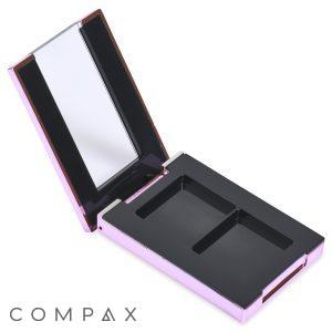 The Double Pan Rectangular Compact, showcasing an open, empty design and a pink metallic finish, is displayed. The inside cover features a mirror, while the basin includes two empty compartments for makeup products.