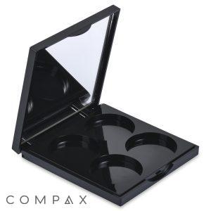 The 4 Well Square Compact with Mirror is an open black makeup palette featuring an attached mirror on the inside of the lid. It contains four empty circular slots designed to hold makeup products like eyeshadows, blushes, or powders.