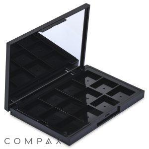The 12 Well Rectangular Compact is an open black makeup palette featuring an empty grid layout and a built-in mirror on the inside of the top lid. The grid layout is designed to be filled with individual makeup pans or products.