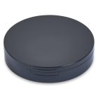 The Single Well Round Compact with Mirror features a sleek, round, black case with a matte finish. It includes a subtle hinge on one side, hinting at its ability to open. The design is minimalistic and modern, completely free of visible logos or designs.