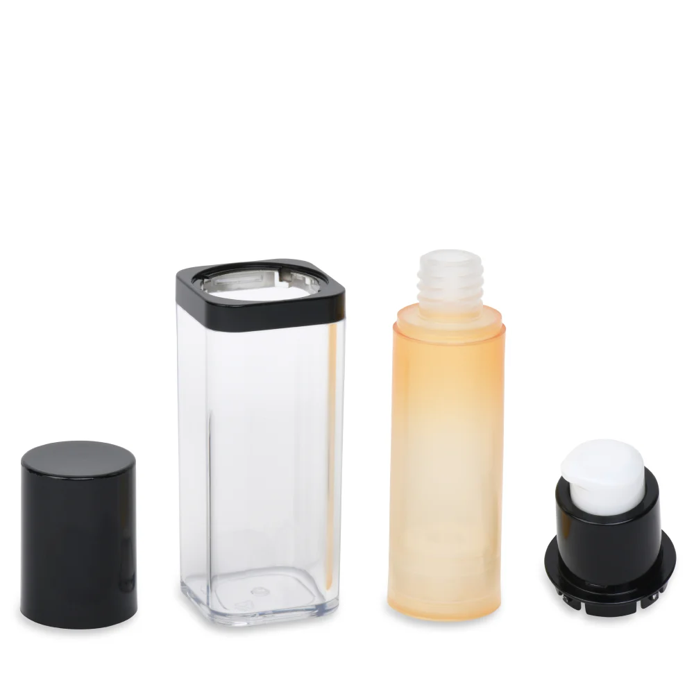 An airless pump bottle that has been deconstructed and its parts arranged on a white background. From right to left the picture shows the black cap, clear outer case, light yellow inner bottle and black and white pump top. 