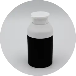 A small, cylindrical bottle with a black lower half and a white upper half, featuring a white flip-top cap. The bottle is placed against a plain white background.